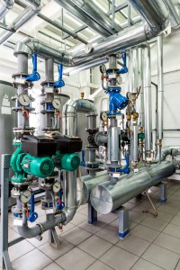 interior gas boiler room with multiple pumps and piping